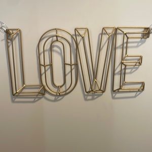 Gold “LOVE” wall sign